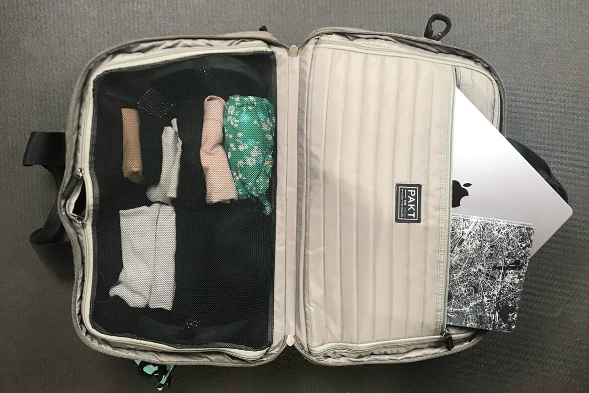 Hand luggage packed with Mac and notebook